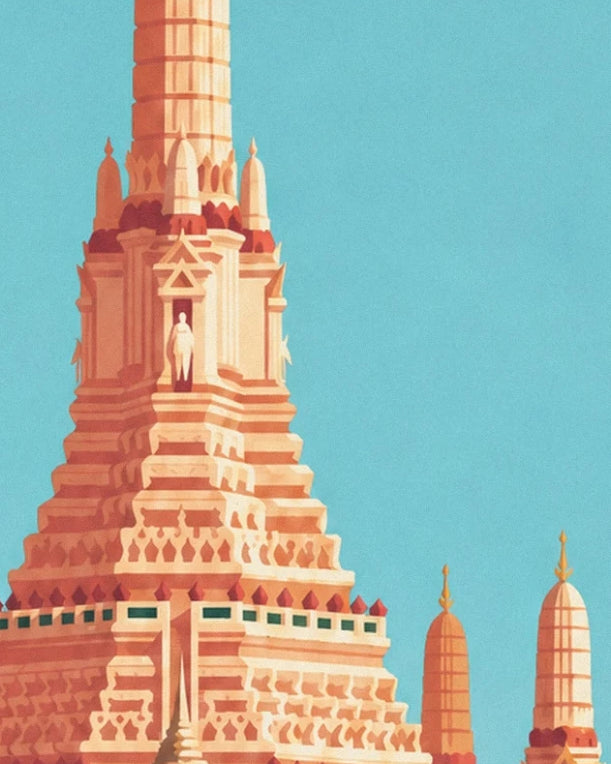 The temple's tall pink stone tower and its small prangs, beneath a turquoise sky