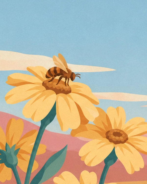 A bee resting in the centre of a yellow flower, in front of the pink hills
