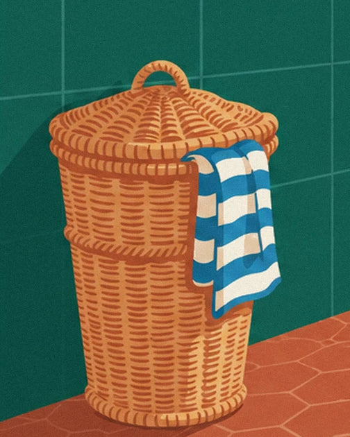 The wicker basket with its lid and blue and white striped towel
