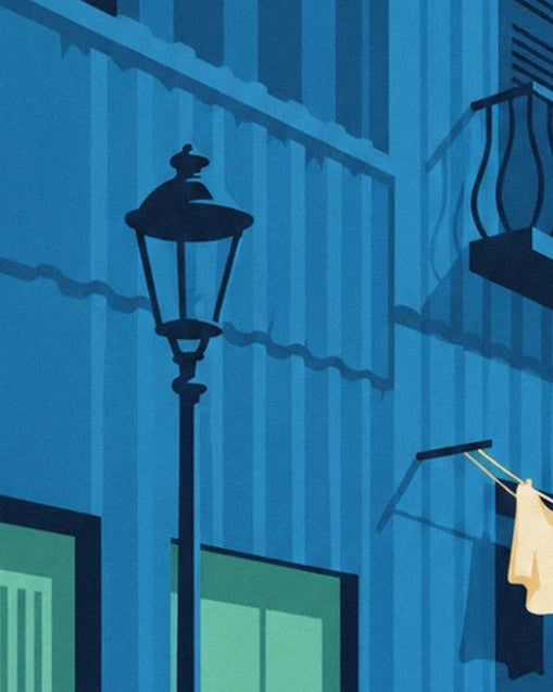 A black street lamp in front of blue corrugated metal façades, with laundry hanging out to dry