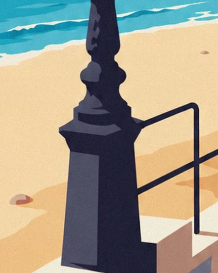 The carved base of a dark lamppost and the black railing in front of the golden sand
