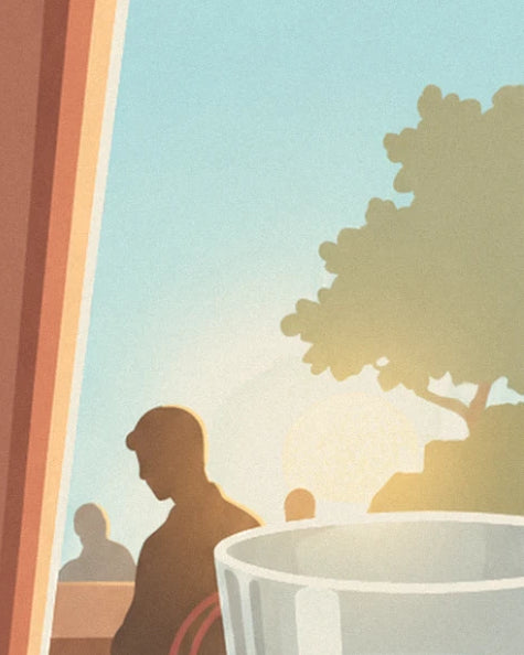Un client en contre-jour à la terrasse, un grand arbre et le soleil bas derrière le verre