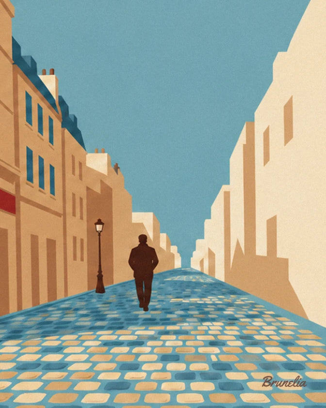 A walker in a dark jacket heading away along the blue cobbles of a Parisian street lined with buildings