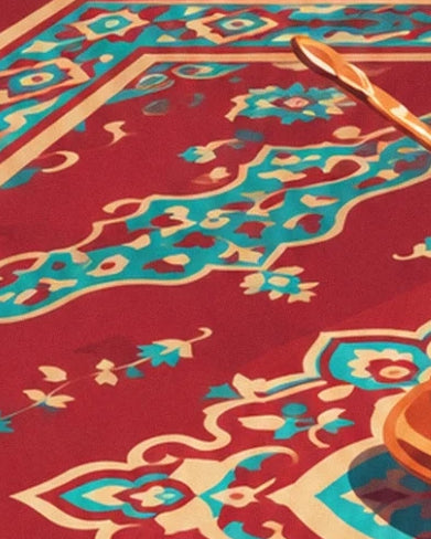 The red rug with turquoise and cream patterns and a copper spoon along its edge