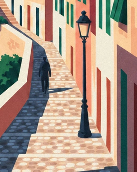 A cobbled lane in Suquet with a black lamppost and a passer-by in the shade