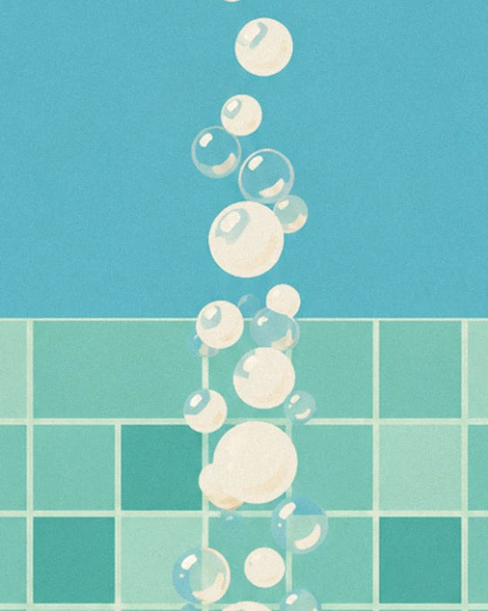 Soap bubbles floating up in front of the pale aqua tiles and blue wall