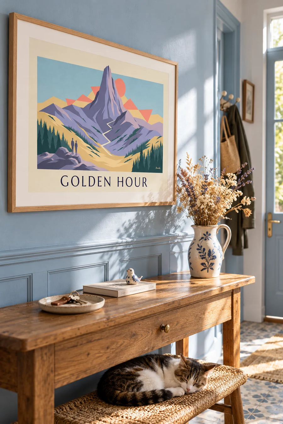 Poster of hikers facing a peak at sunset: framed on the wall