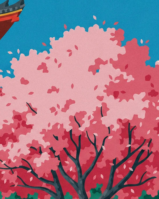 The cherry branches laden with pale and deep pink blossom against the blue sky