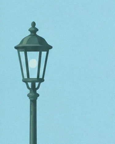 A dark green street lamp with a glass lantern against a blue sky