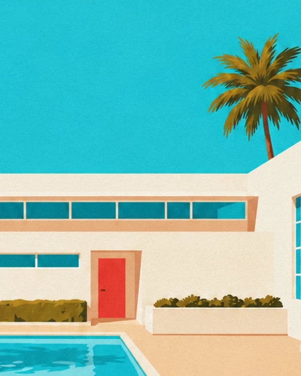 The villa's white façade, red door and hedges, with a palm tree behind