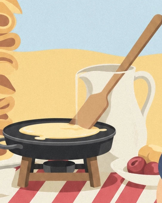 The black crêpe pan, its wooden spatula and the white jug on the striped tablecloth