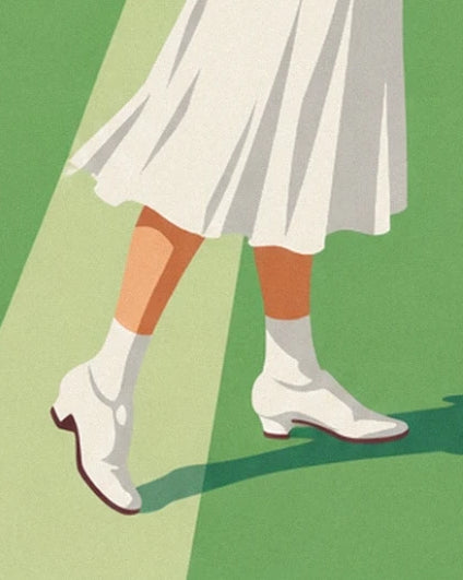 The white shoes with small heels on the grass beneath the pleated skirt