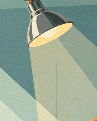 A grey metal workshop lamp and its broad yellow beam on the green wall