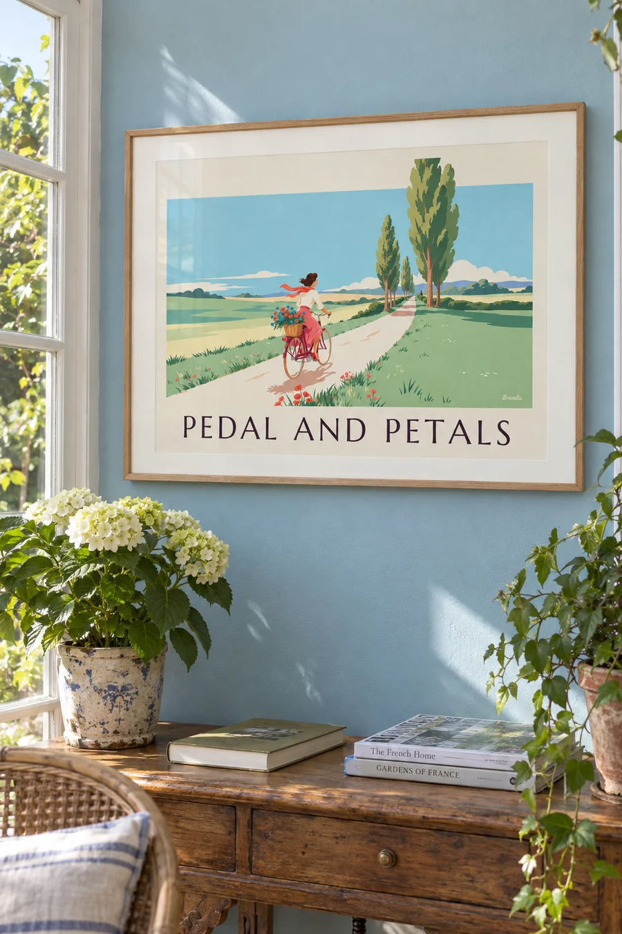 Pin-up on a bicycle with a basket of flowers in the countryside poster: framed on the wall
