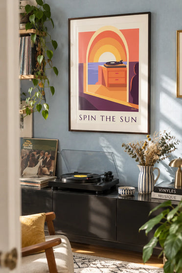 Poster of a vinyl turntable in front of a large setting sun: framed on the wall