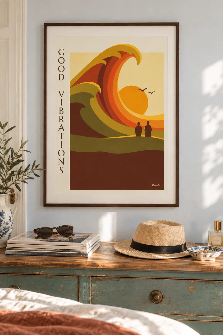Abstract poster with undulating shapes and a rising sun: framed on the wall